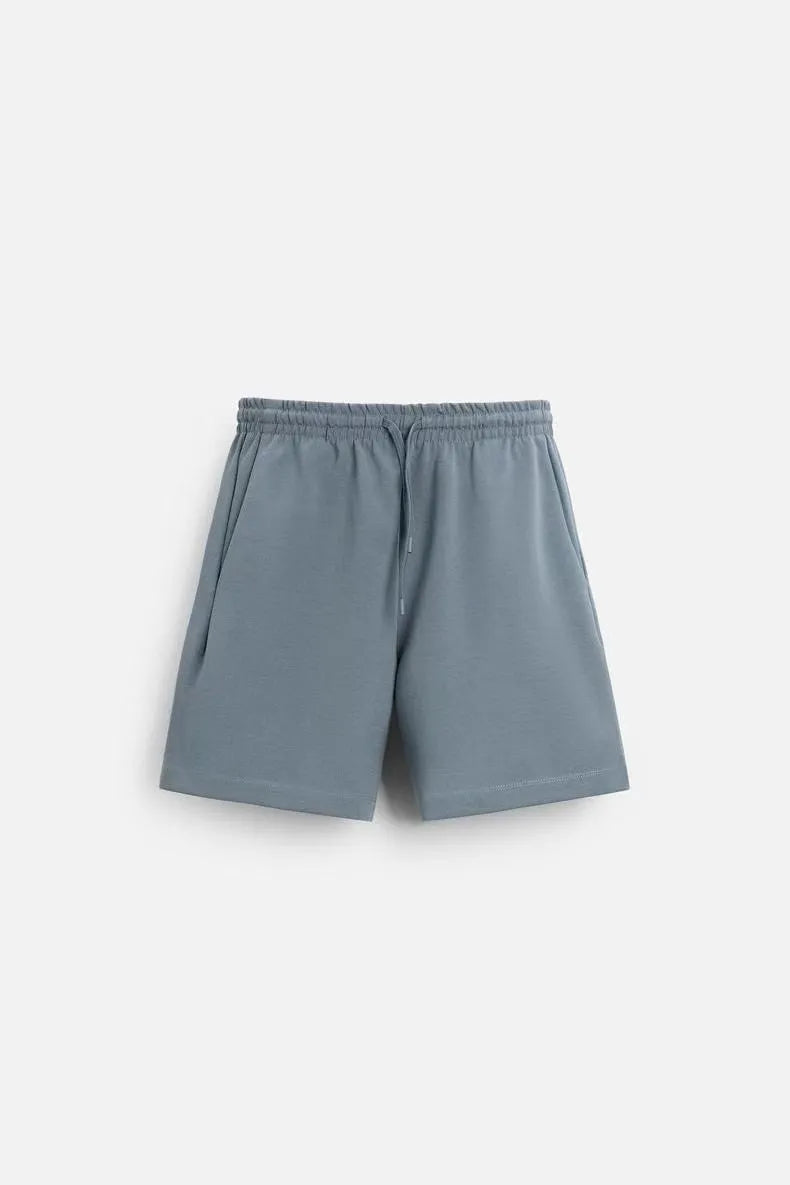 Loose double-sided cloth texture short sleeve shirt and matching shorts in blue, laid flat.