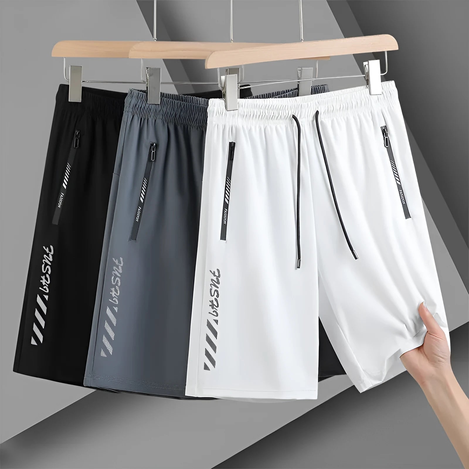 Men's black loose-fit nylon sports shorts on a hanger