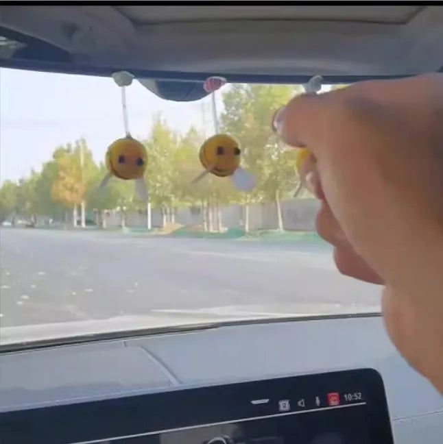 Swing Spring Bee soft fur ball car decoration with cartoon bee shape on adhesive backing.