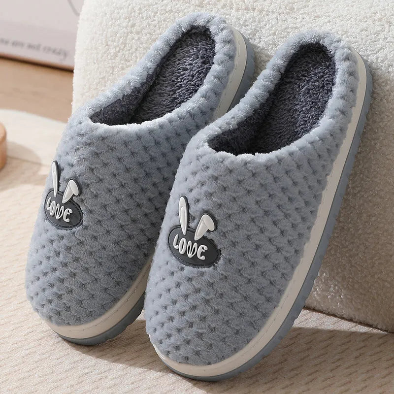 Women's plaid design house slippers with artificial fur upper and thick rubber sole in various colours.