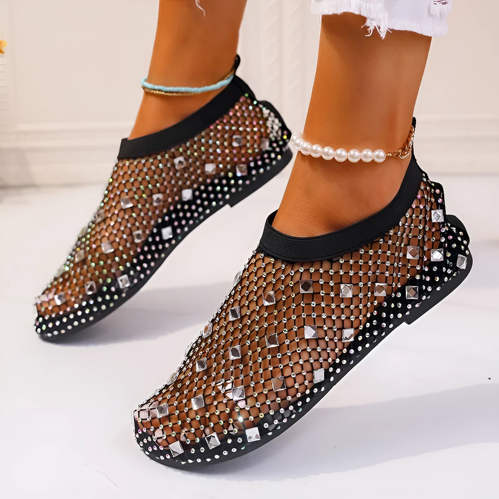 Women's colourful rhinestone and white mesh flat sandals on a rubber sole.