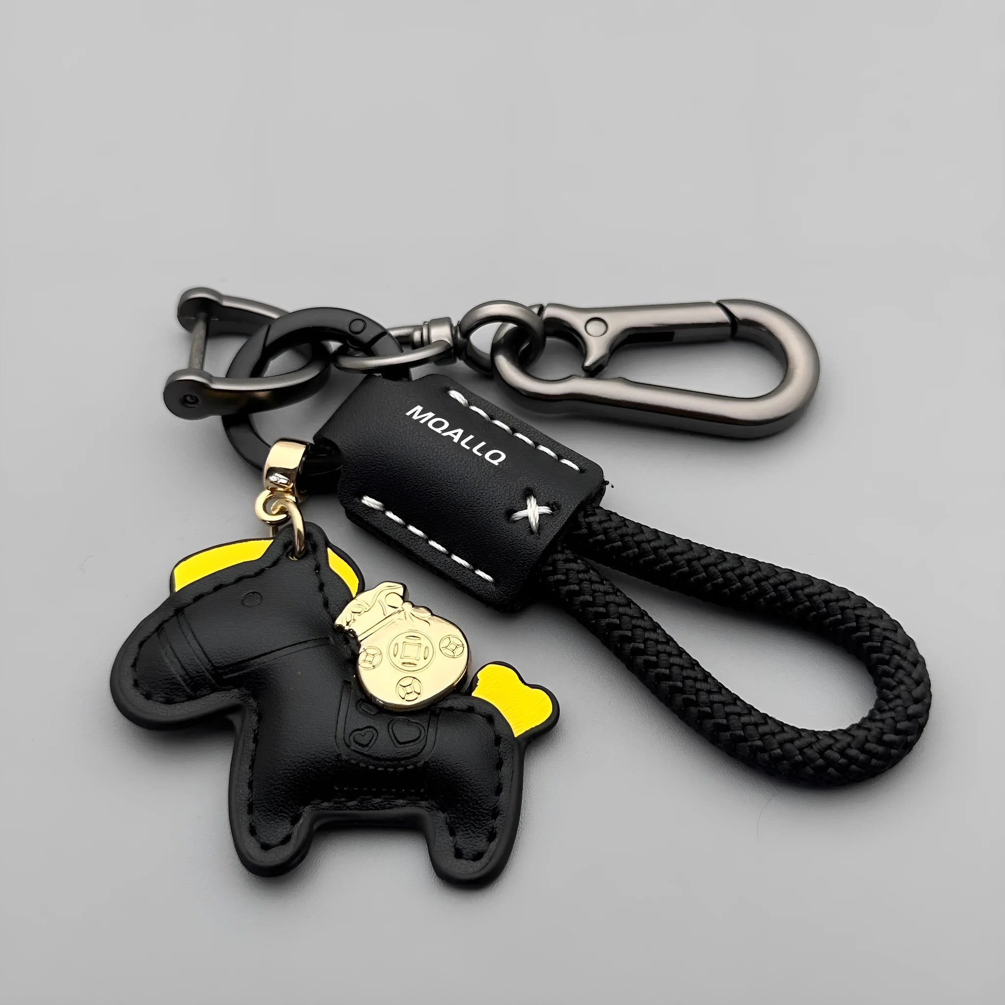 Handmade brown cowhide leather key ring pendant with a gold-toned zinc alloy pony belt buckle and green flanelle rope.