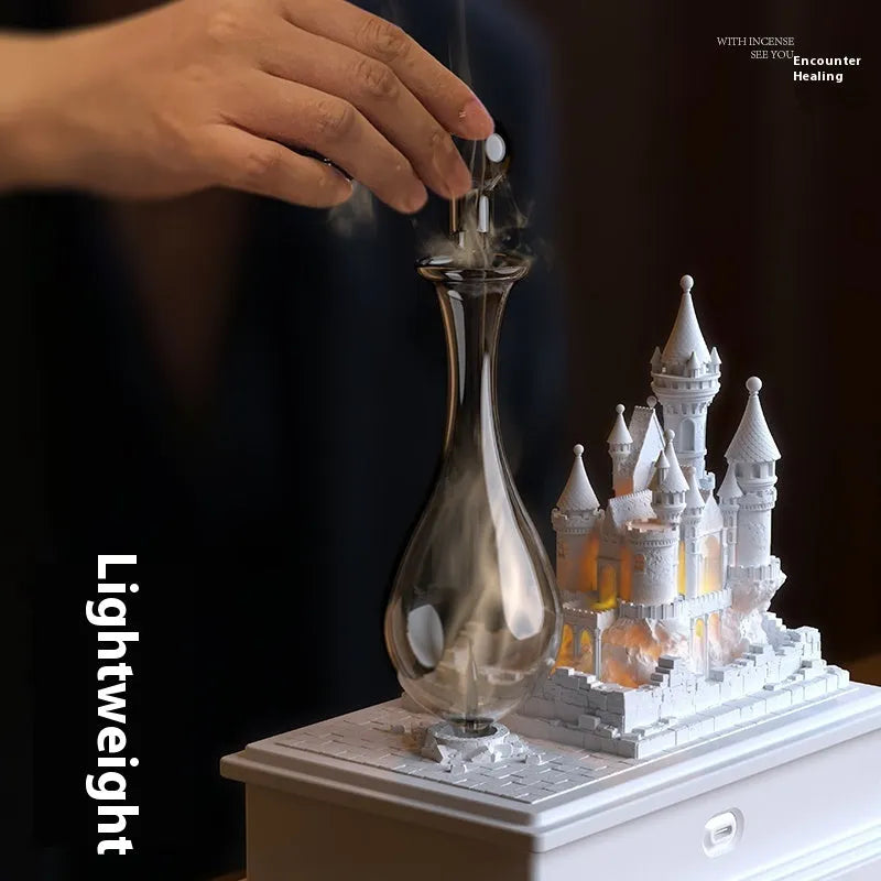 White medieval castle ornament aromatherapy machine with ambient light on a table.