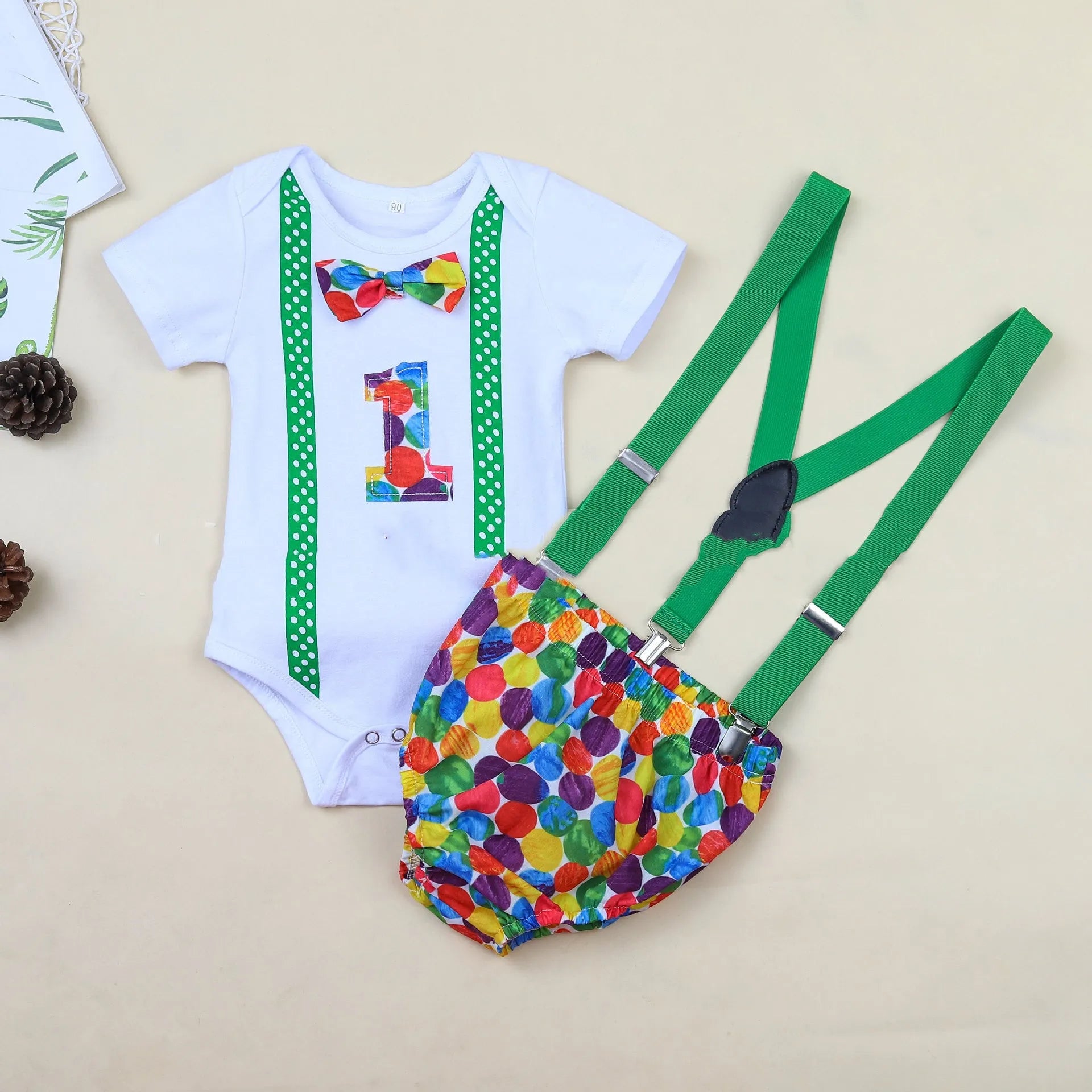 Baby in a soft cotton dinosaur print romper with shorts, showing the pullover design and clean finish.