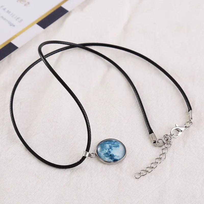 Close-up of a constellation design glass pendant on an alloy chain necklace with extension.