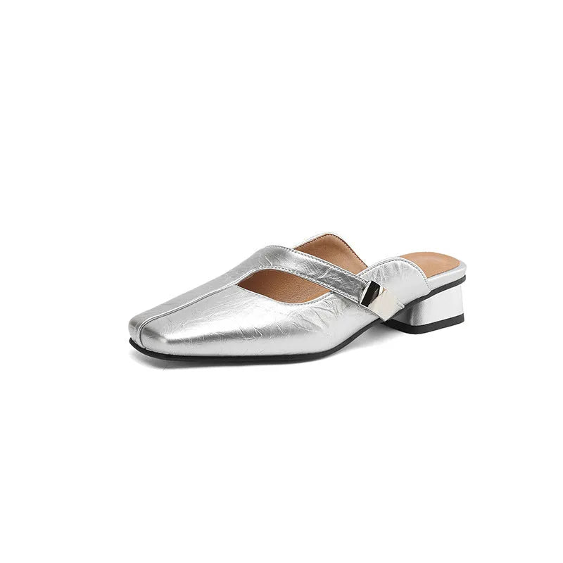 A pair of casual square-toe low-heel slippers in a solid colour on a rubber sole.