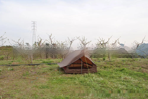 Brown A-line pole-free cabin tent pitched with hiking canes showing spacious interior dimensions
