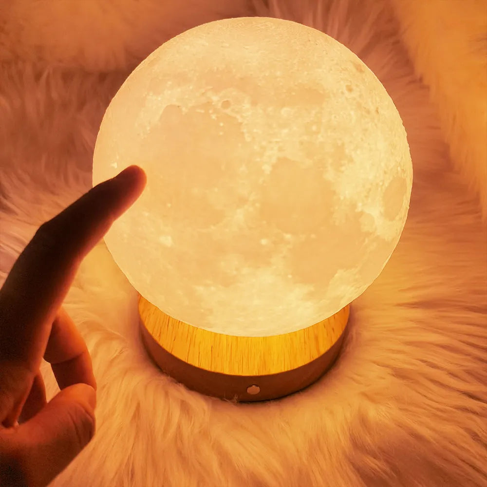 Rotating moon night lamp with wooden base showing three colour modes