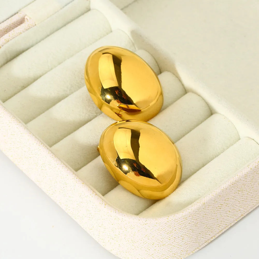 Geometric stainless steel ear studs with exaggerated glazed surface finish in DFE139 colour