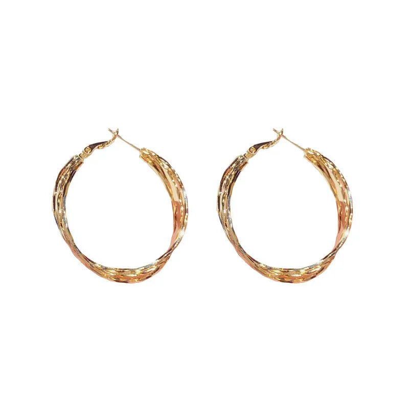 Silver Needle fashion simple metal twisted earrings in gold electroplated finish on copper base, round geometric shape