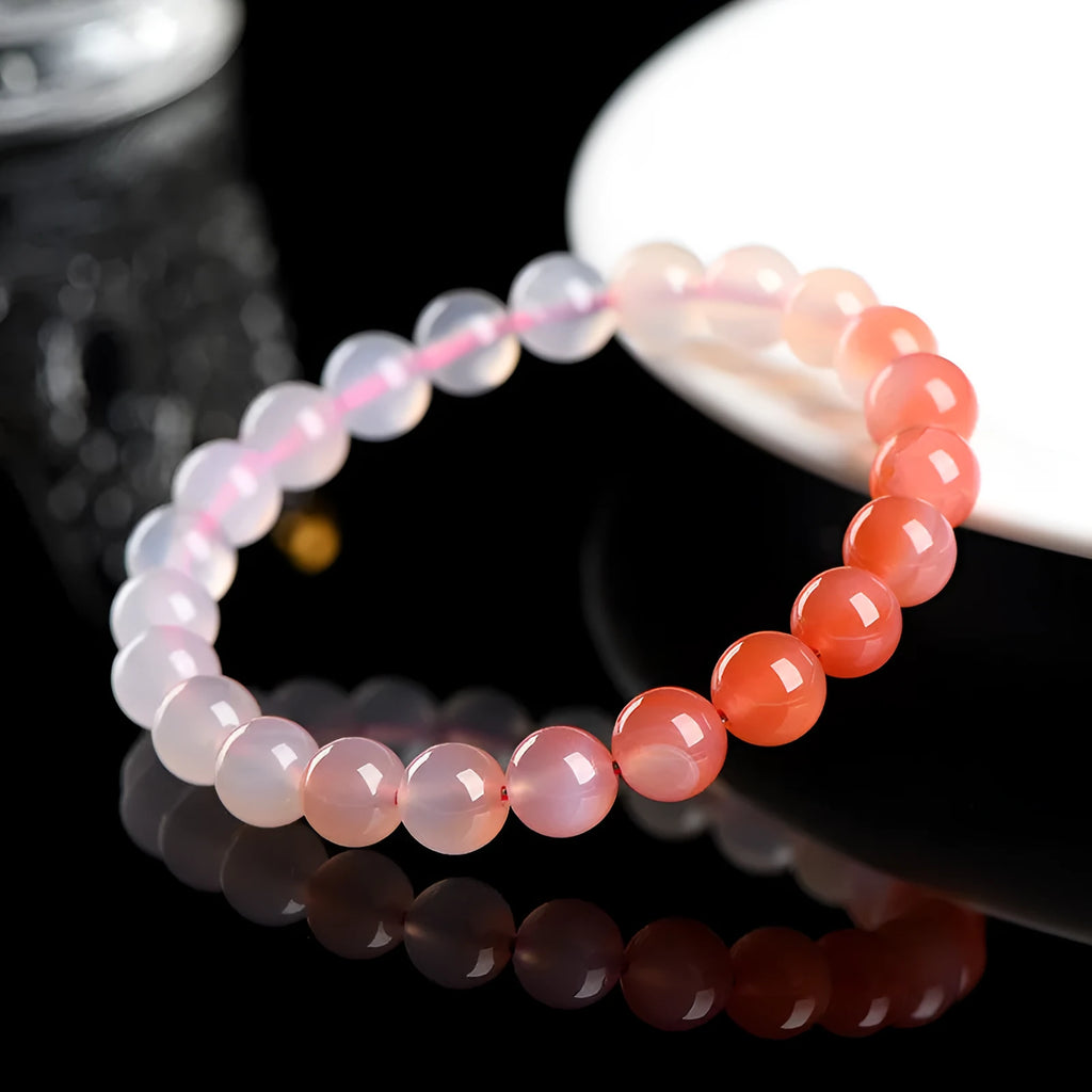 Natural gradient Yanyuan agate bracelet with geometric beads on a wrist.