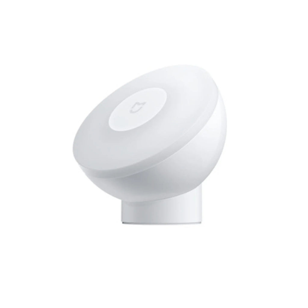 White modern bedside table lamp with sensor and Bluetooth on a wooden nightstand.