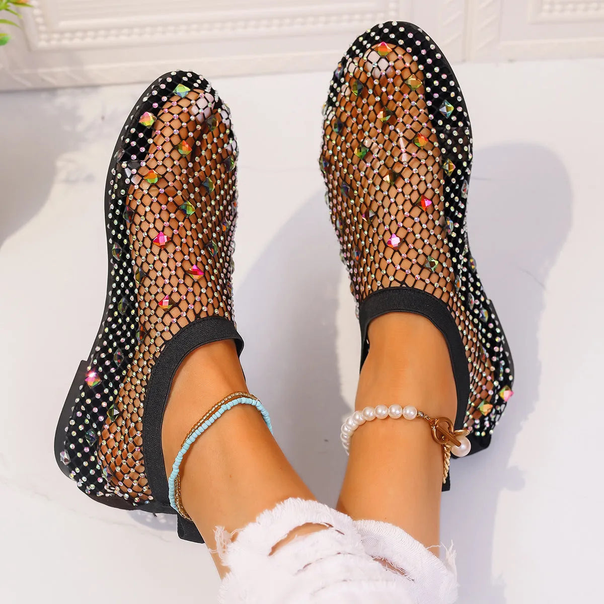 Women's colourful rhinestone and white mesh flat sandals on a rubber sole.