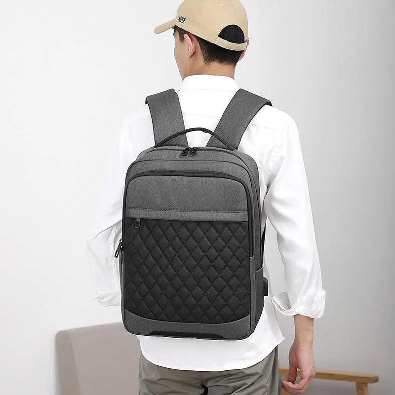 Men's Oxford cloth travel backpack in black with curved shoulder straps and diamond mesh panels