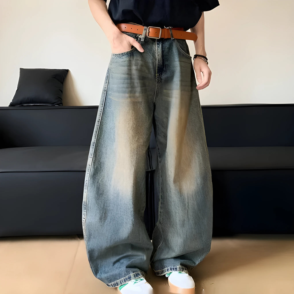 Man wearing retro blue distressed wide-leg denim jeans with machete detailing
