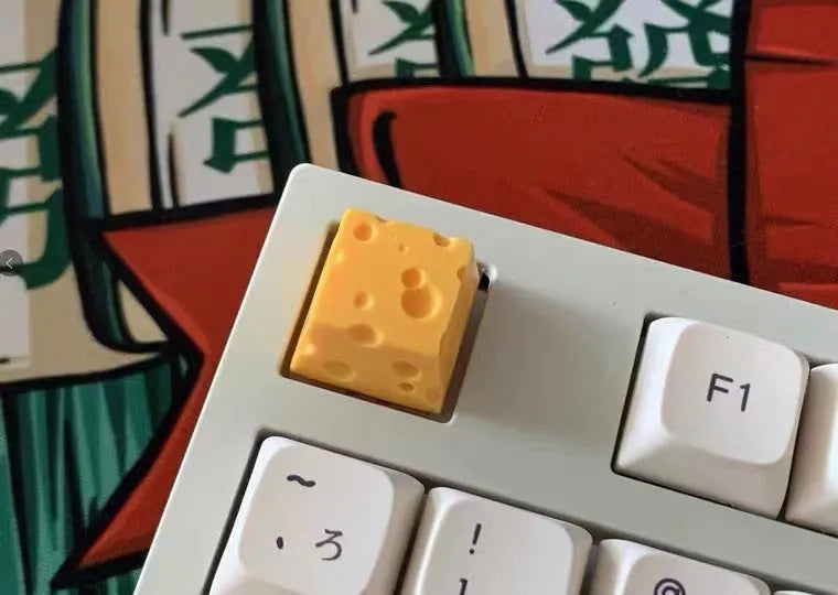 Solid yellow resin artisan key cap with detailed cheese design for MX mechanical keyboards.