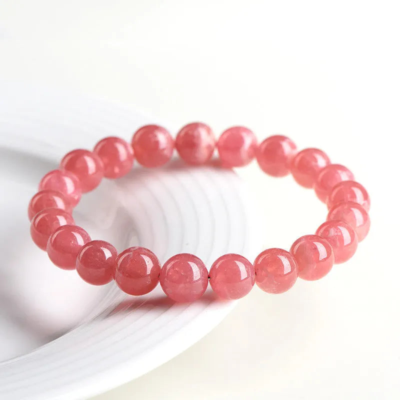 Women's geometric crystal bracelet with Longevity Lock design and red rhodochrosite stone beads.