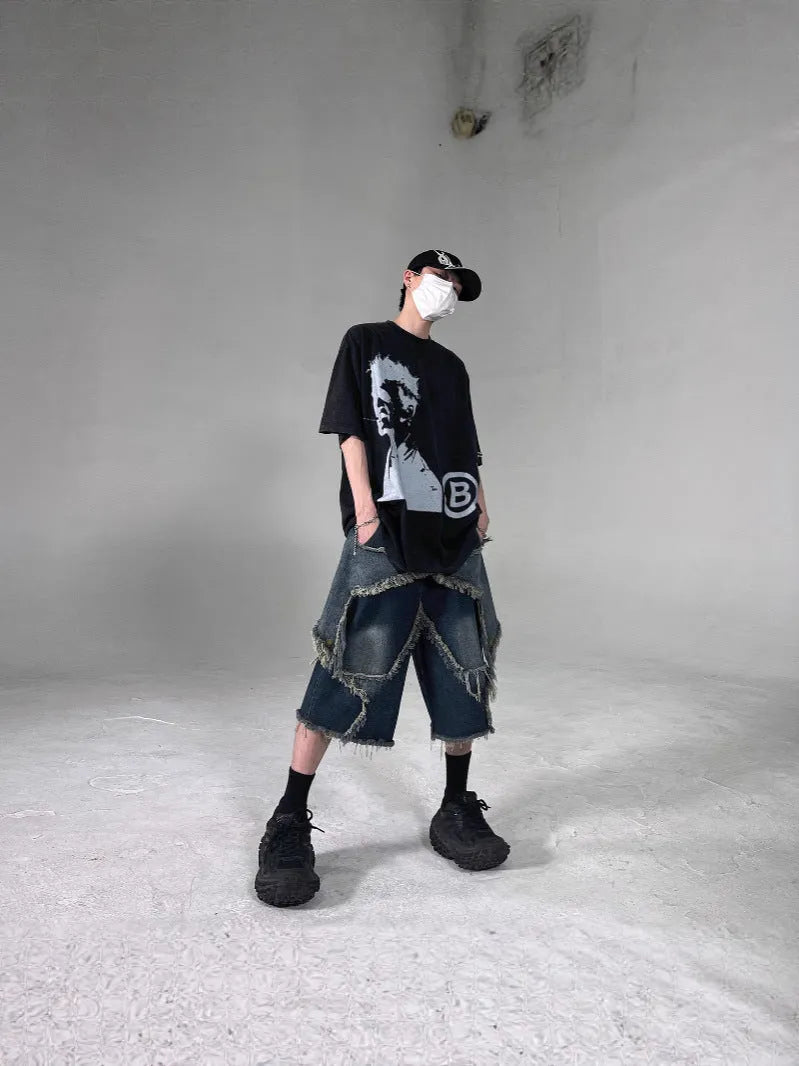 Blue men's denim shorts with a loose fit, frayed hem, and an embroidered five-pointed star on the leg.