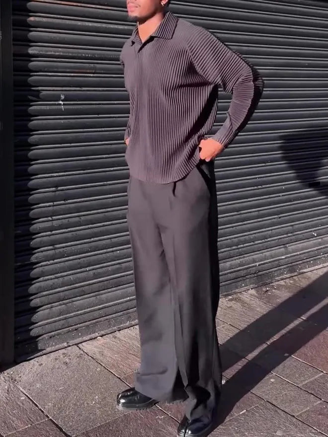 Men's black long-sleeved casual top with a pleated detail on the front.