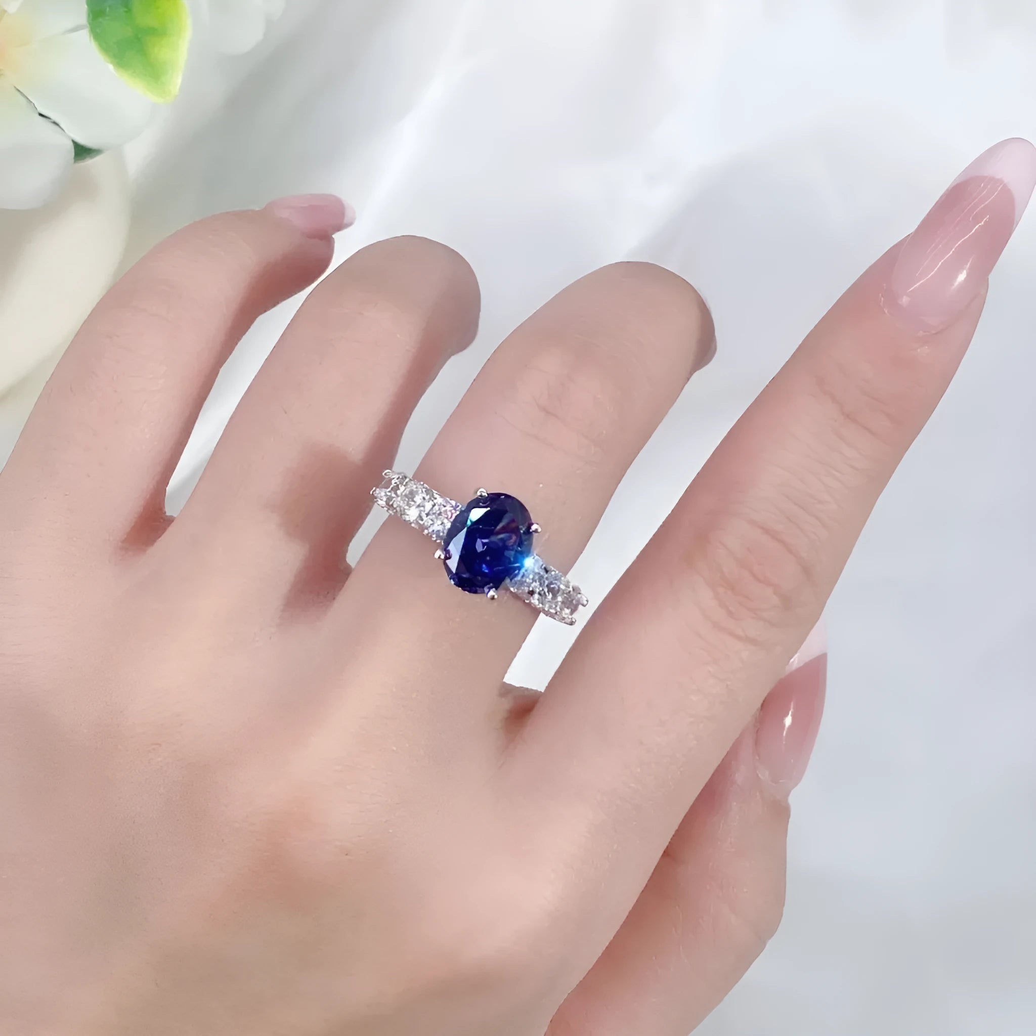 Close-up of a women's heart-shaped sterling silver ring with a faceted ice flower cut zircon gemstone.
