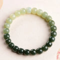 Natural Hetian jade bracelet with water gradient colour on polished beads, unisex casual style.