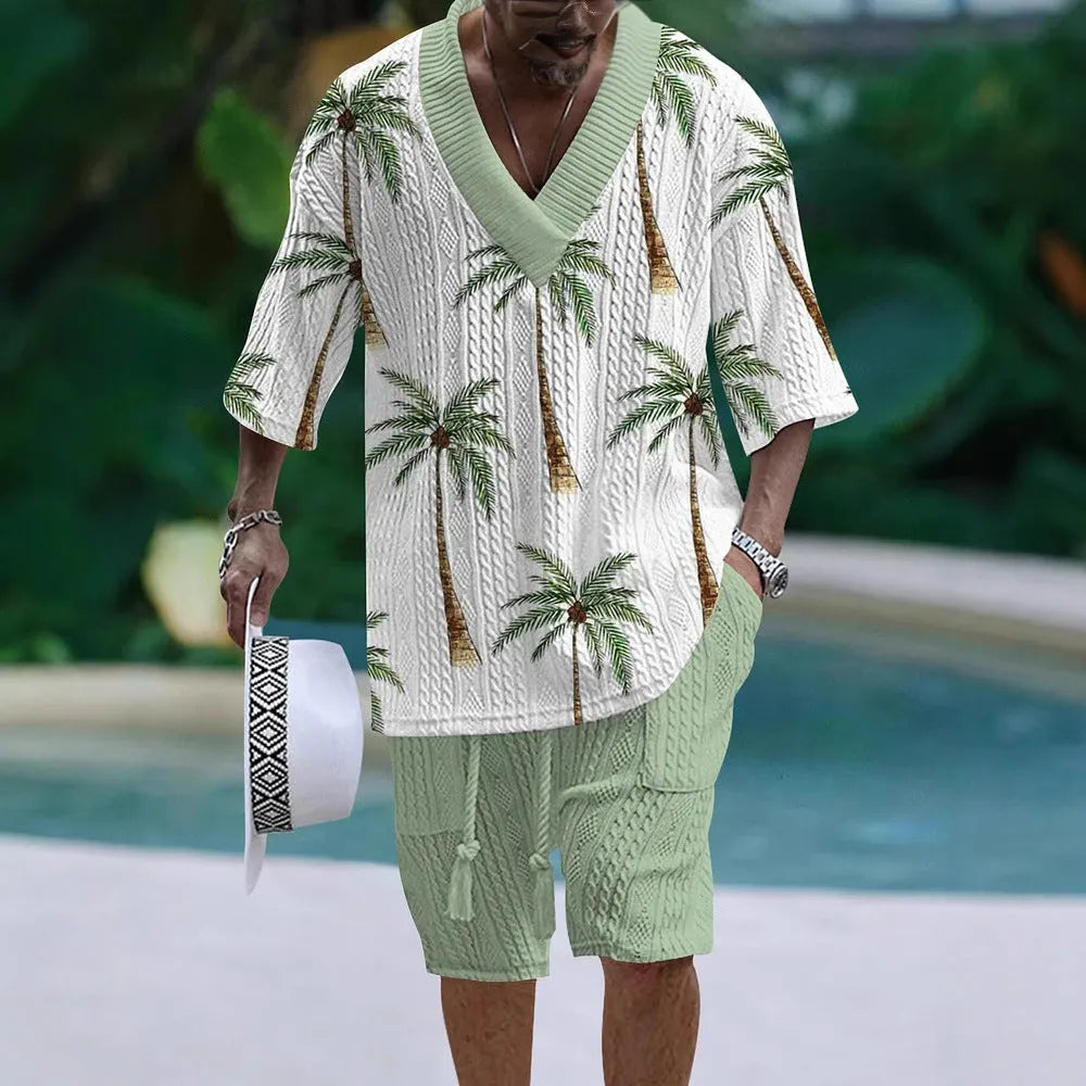 Man wearing a loose fit casual short sleeve suit with matching shorts in a light colour.