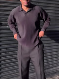 Men's black long-sleeved casual top with a pleated detail on the front.