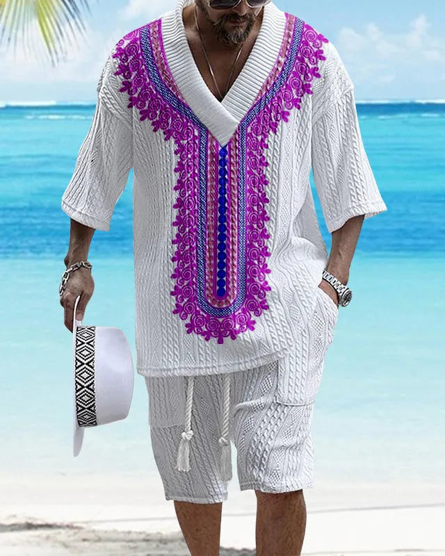 A man wearing a printed drop-shoulder knitted top and matching shorts from a casual two-piece loungewear set.