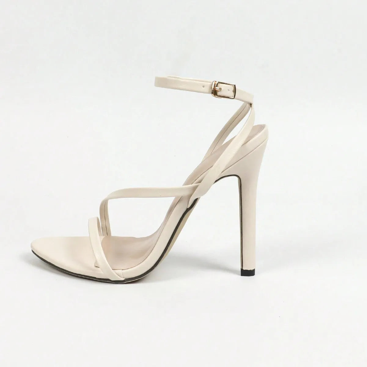 Women's gold open toe high heels with multi-stripe pattern and cross ankle strap on model
