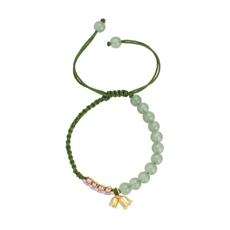 Red rope hand woven women's bracelet with floral design in Lily carrying strap colour