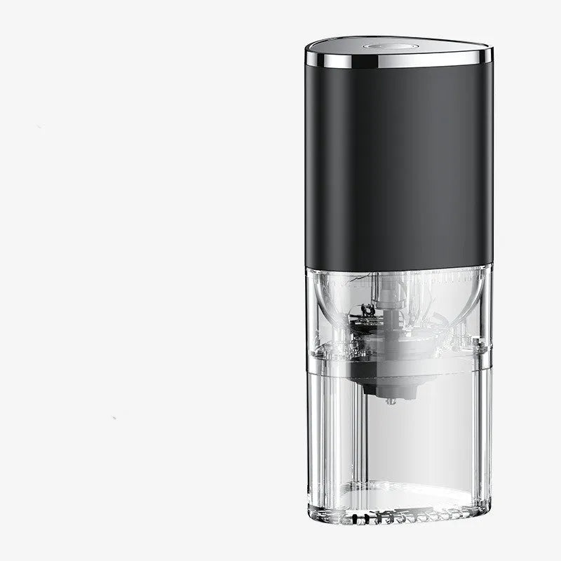 White portable electric coffee grinder with USB charging cable on a wooden table