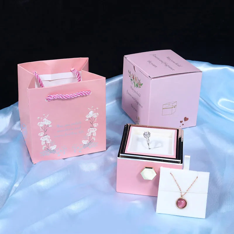 Rotating rose jewellery gift box with preserved real flower under acrylic cover and rotating drawer