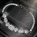 Women's silver-toned geometry bracelet with inlaid clear stones on a model's wrist.