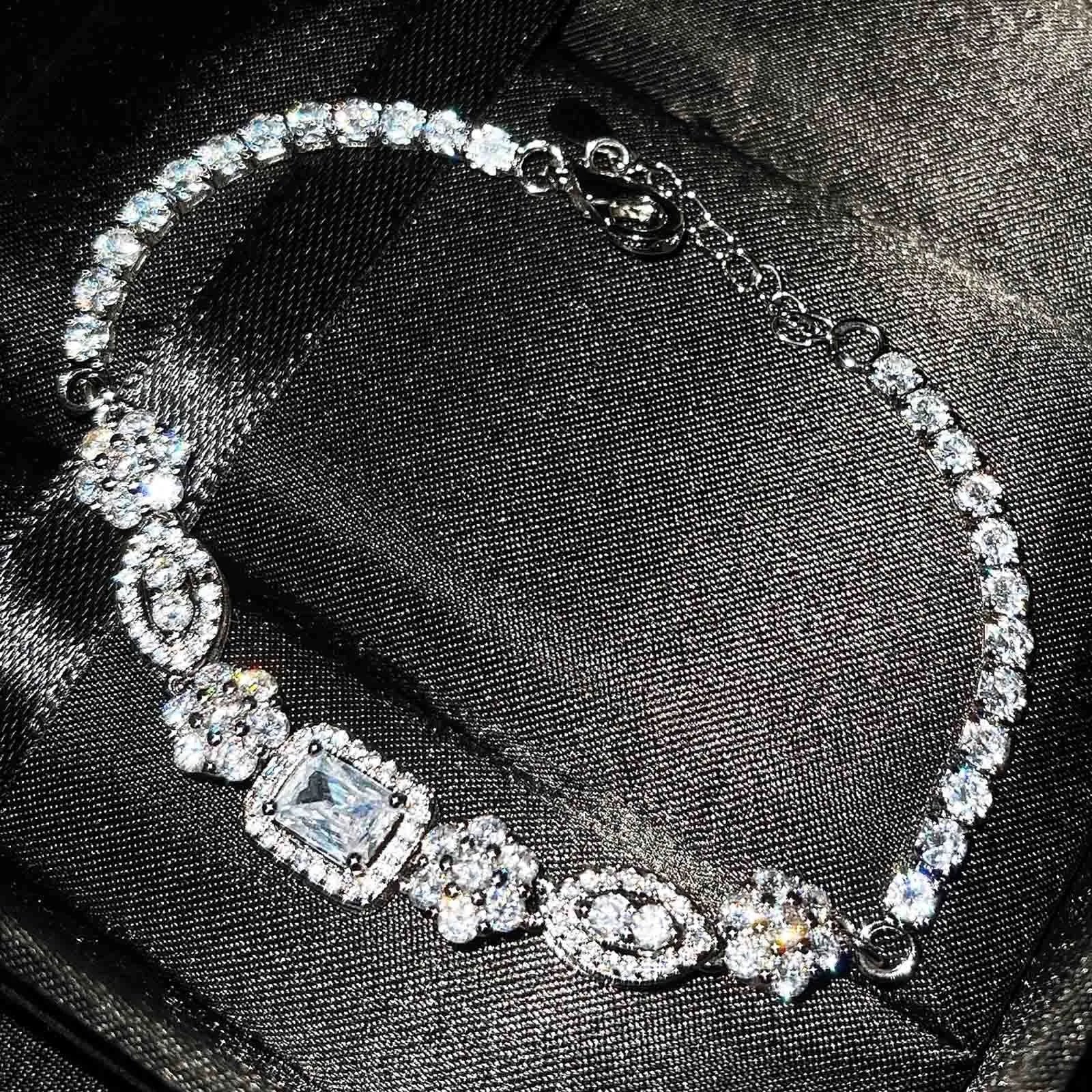 Women's silver-toned geometry bracelet with inlaid clear stones on a model's wrist.