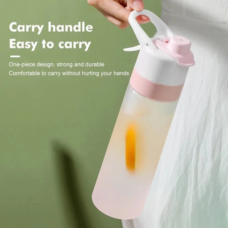 White 700ml plastic spray water bottle with a black handle strap and leakproof lid on a table.