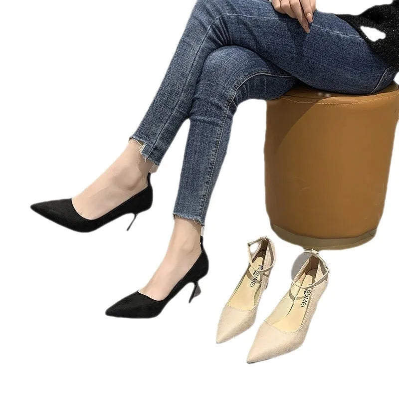 Black and creamy white women's stiletto heel pumps with buckle closure and skull pattern.