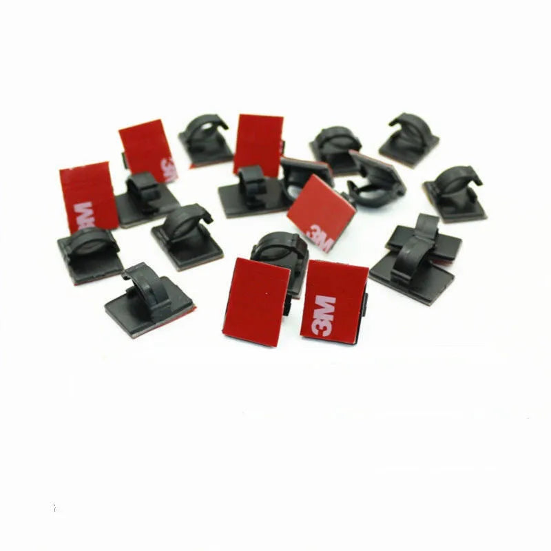 Black and white self-adhesive plastic buckle clamps for organising flat automotive wiring cables