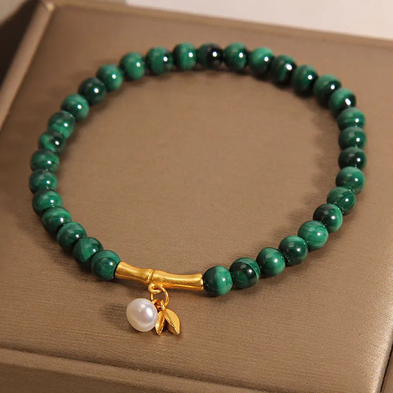 Women's white crystal lucky bamboo bracelet with adjustable clasp on a wrist.
