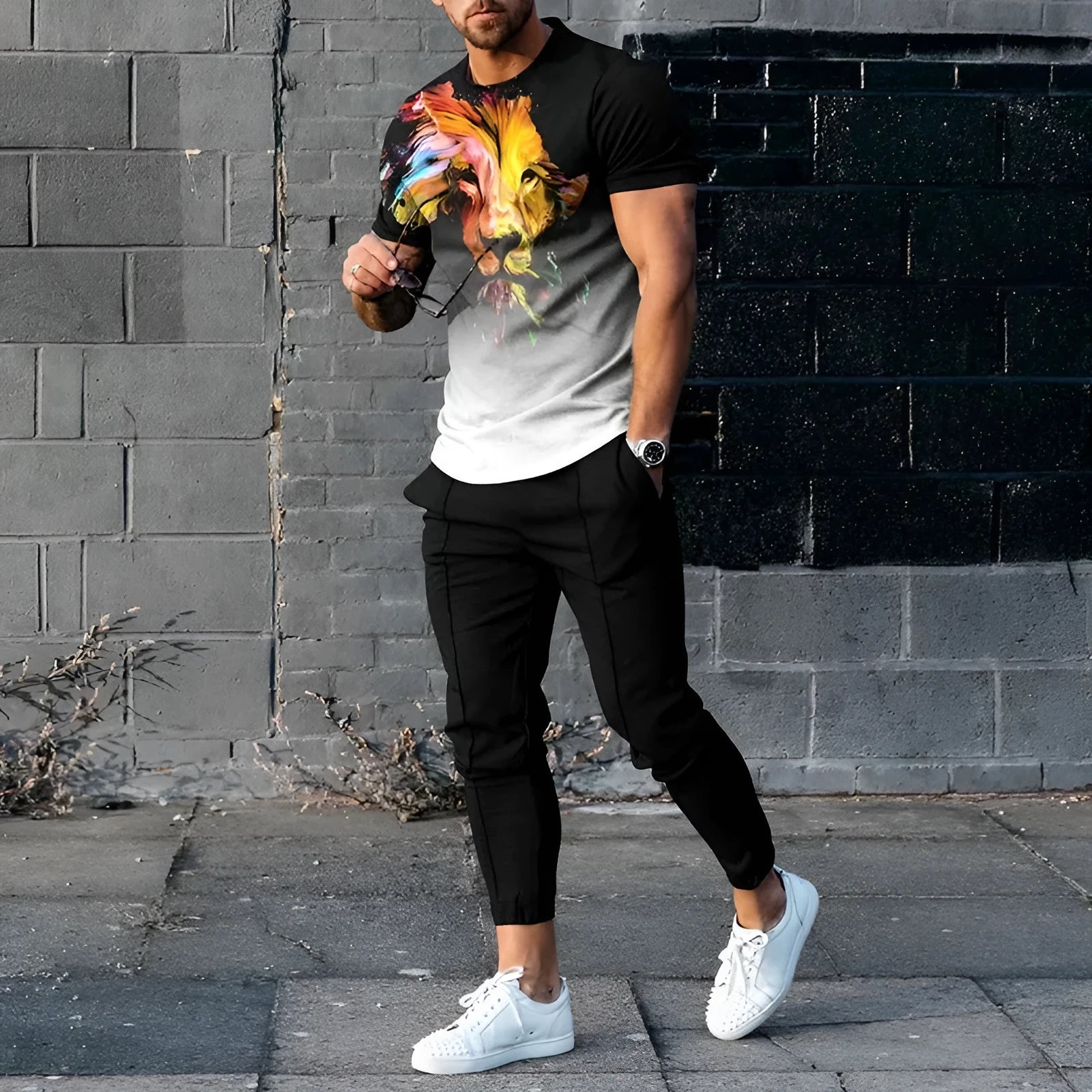 Man wearing a solid colour printed short-sleeve T-shirt and matching trousers from a sportswear set.