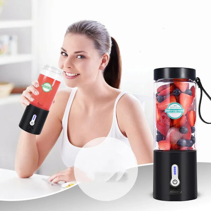 Black portable hand blender with transparent 530ml measuring cup and five-blade cutter head.