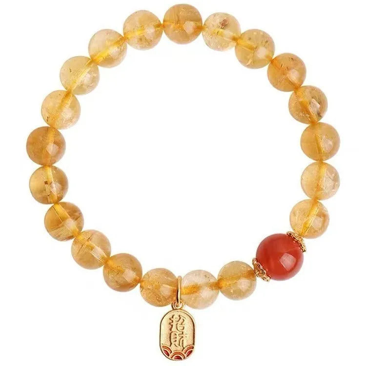 Red agate bracelet with gold ruby accents showing three bead size options on wrist