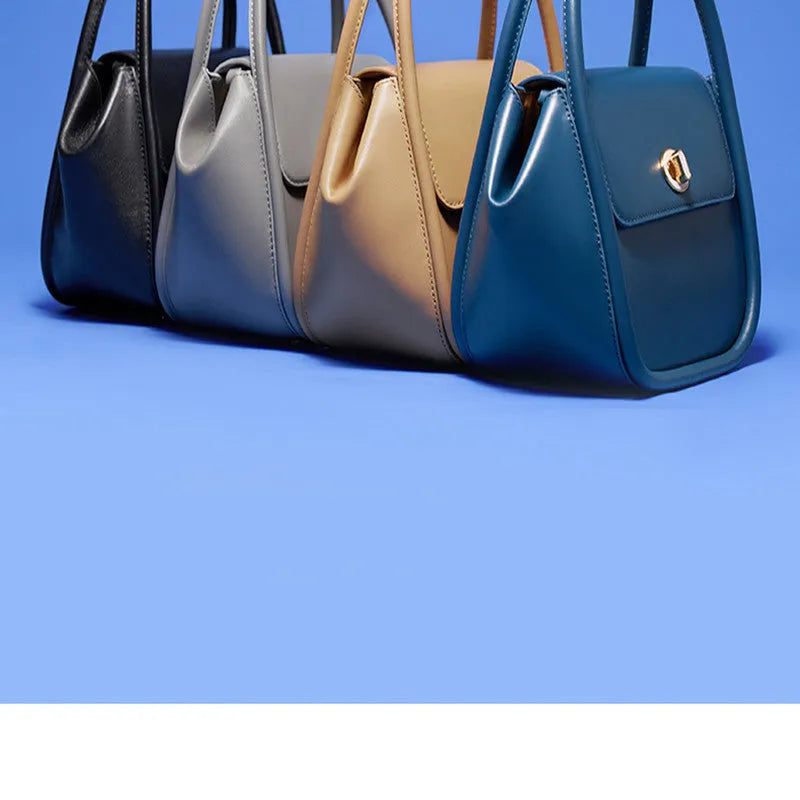 A wing-shaped cow leather women's tote bag with a cross-body strap and latch closure in a choice of colours.