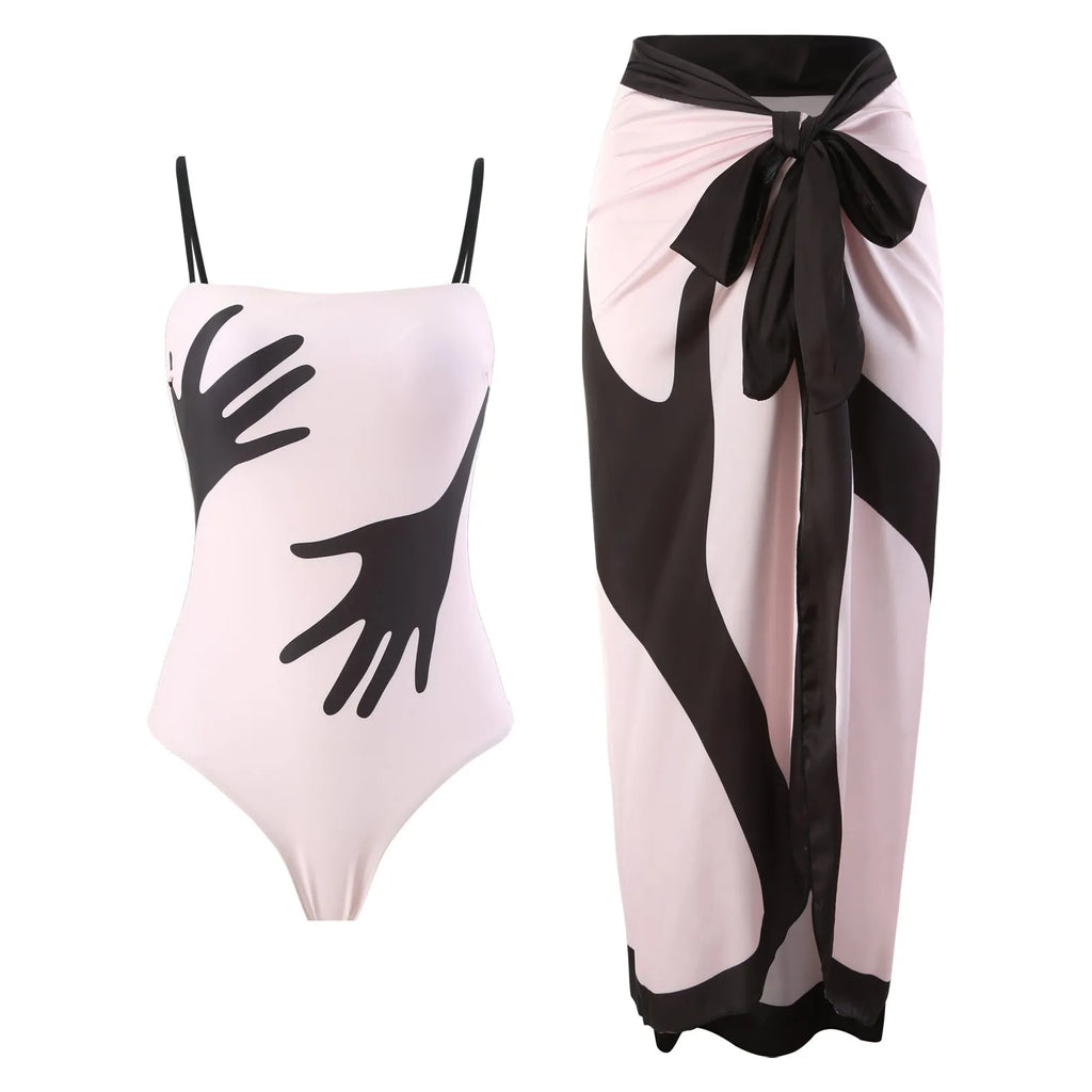 Women's patterned one-piece bikini with a matching lightweight tulle skirt.