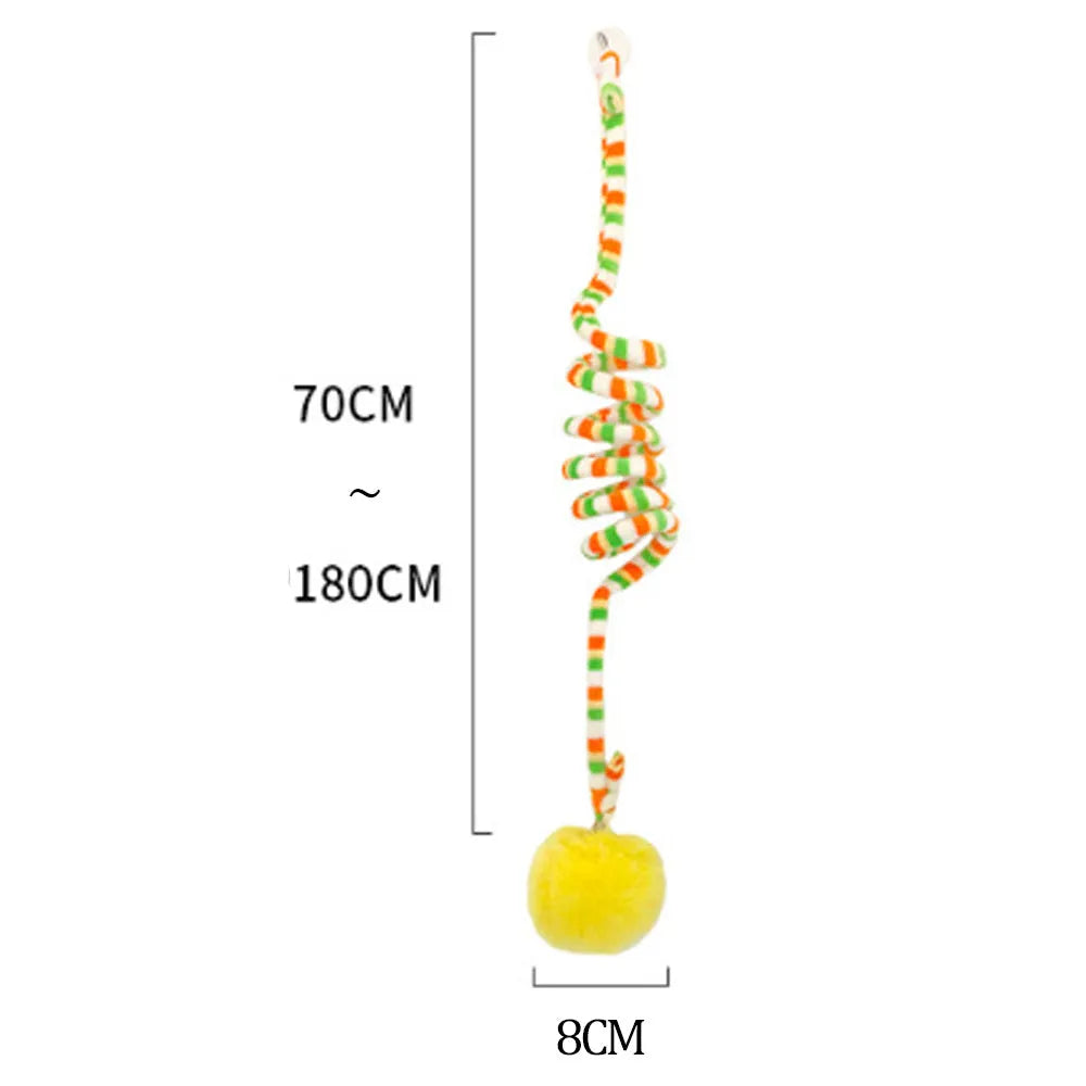 Spring-mounted cat toy with bell stick and inflatable ball, attached to a door via suction cup.