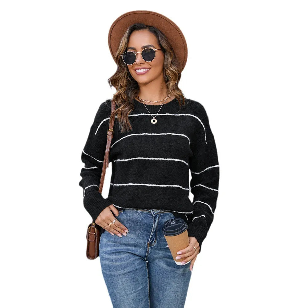 Women's black and white striped pullover sweater with a round neck and loose fit