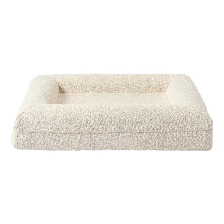 Beige rectangular dog bed nest with raised edges, shown in S and M size options