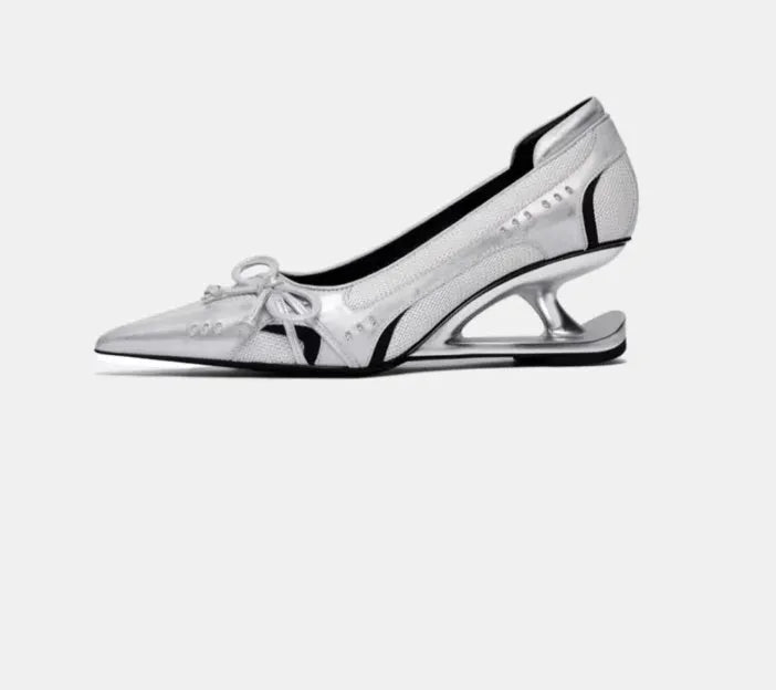 Black women's pointed toe Mary Jane high heels with a distinctive shaped floating heel on a white background.