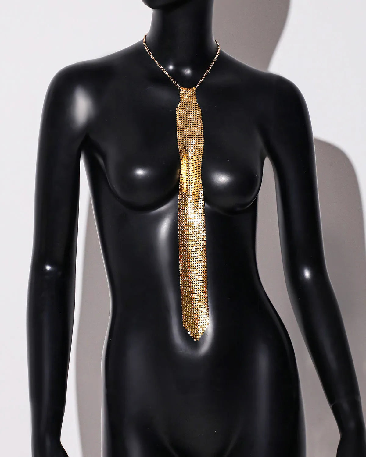 Arrow-shaped metal sequin bow tie with an electroplated finish in silver, black, or gold.
