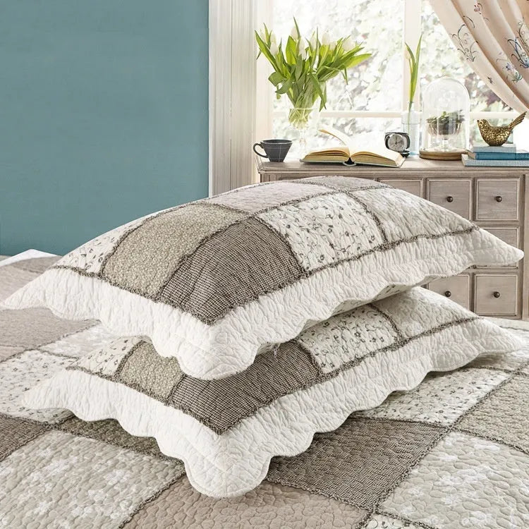 Washed pure cotton quilted bedspread and matching pillowcases set on a bed, shown in a beige colour option.