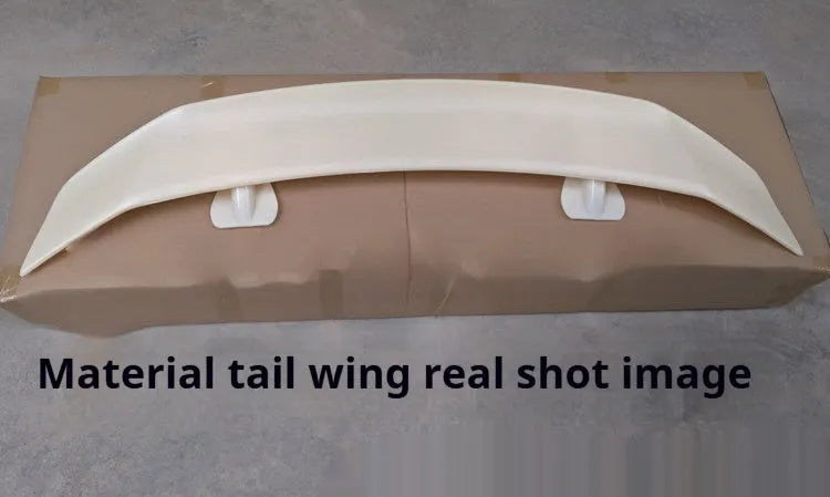 Universal punch-free car spoiler tail wing in ABS plastic on a vehicle.
